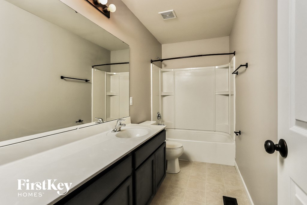 a bathroom with a sink and a toilet and a shower