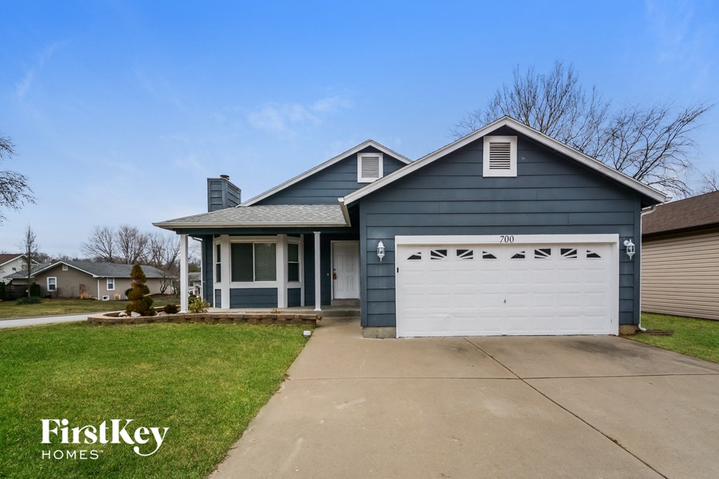 a blue house with a white garage door