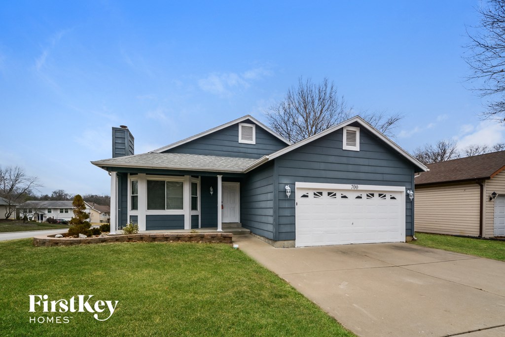 a blue house with a white garage door