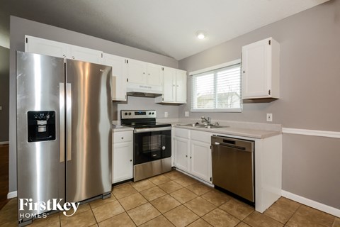 a kitchen with stainless steel appliances and white cabinets