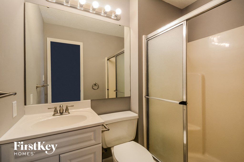 a bathroom with a sink toilet and a shower