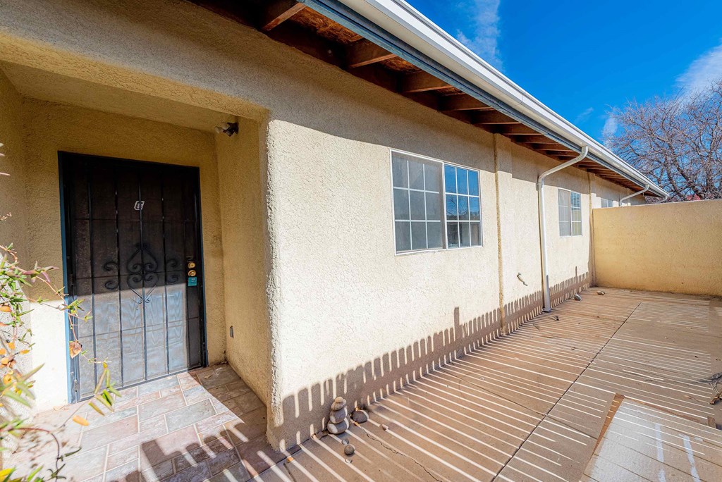 the front of a house with a wooden deck
