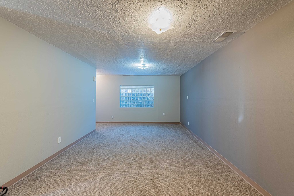 a empty room with white and blue walls and carpet