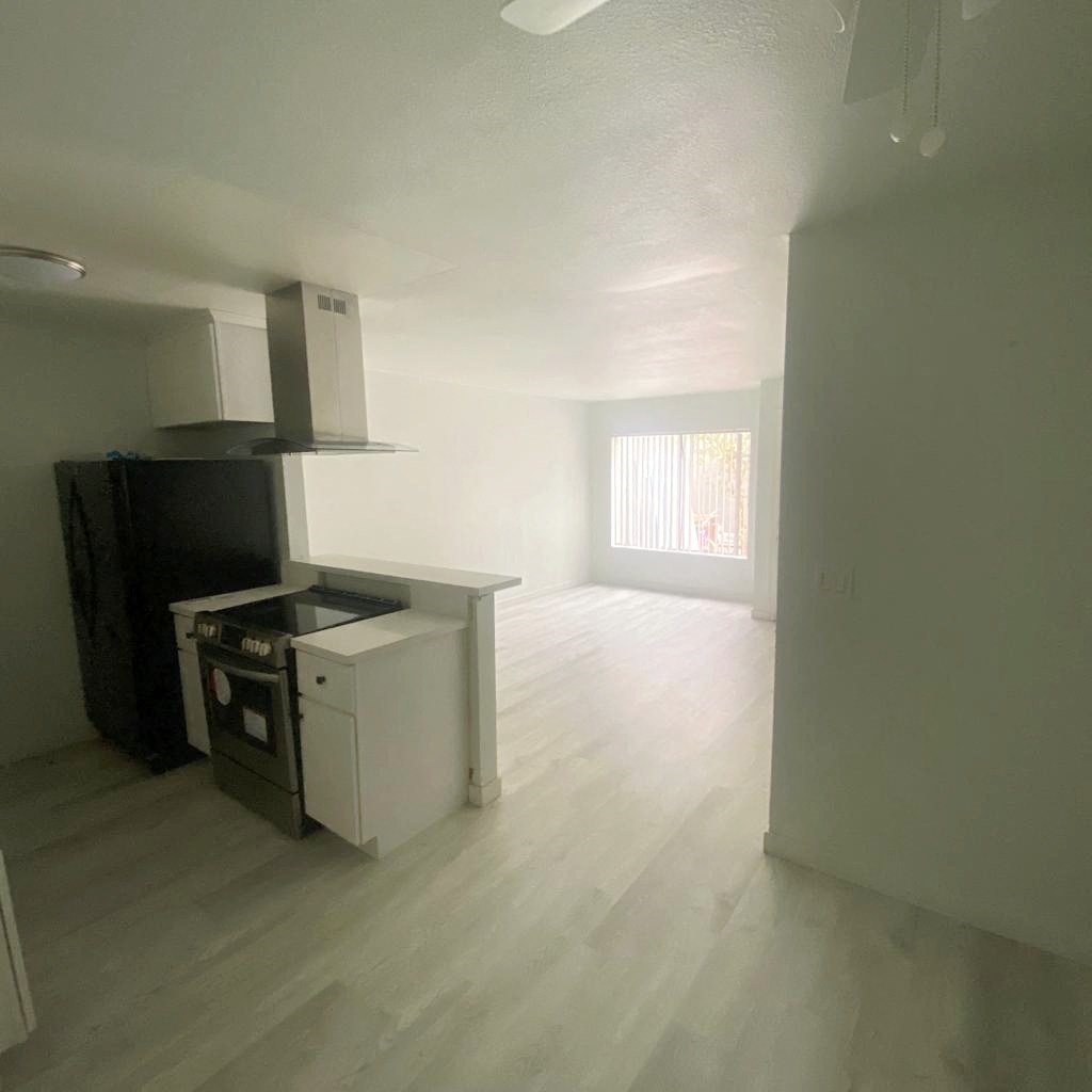 an empty kitchen and living room in an empty house