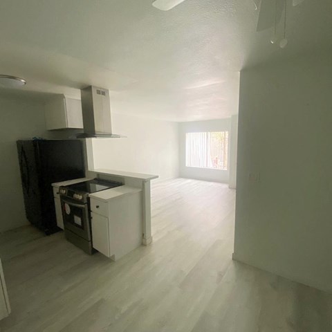 an empty kitchen and living room in an empty house