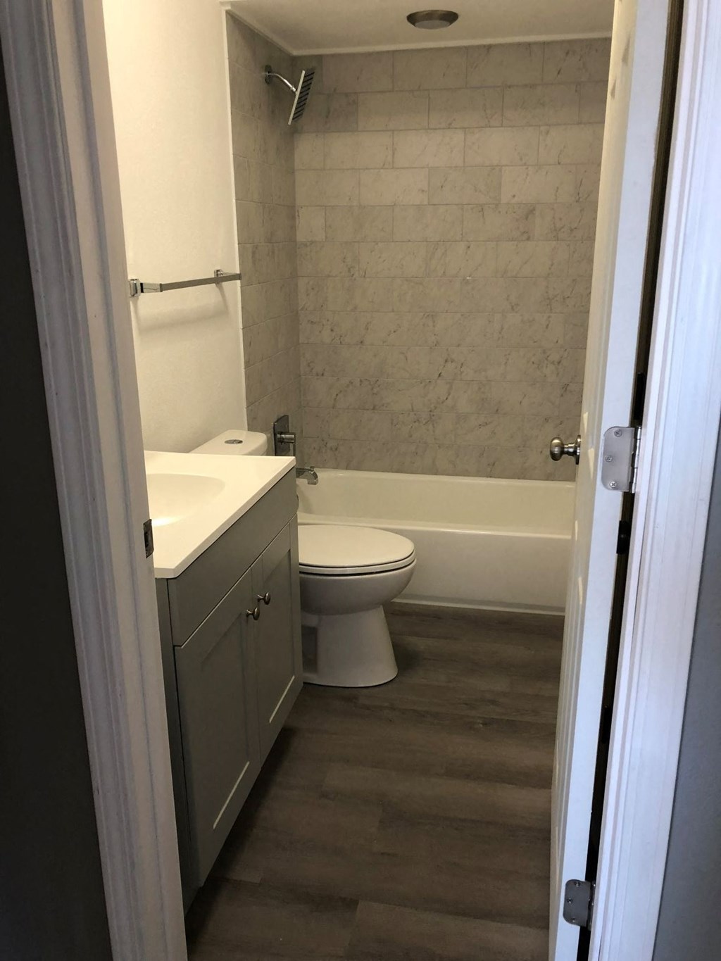 a bathroom with a toilet and a sink and a bath tub