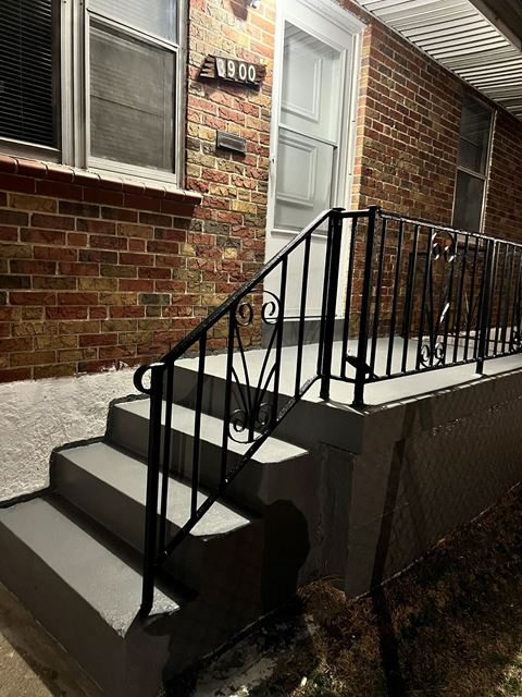 a pair of stairs in front of a brick building
