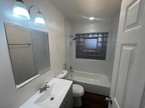a bathroom with a sink toilet and a bath tub