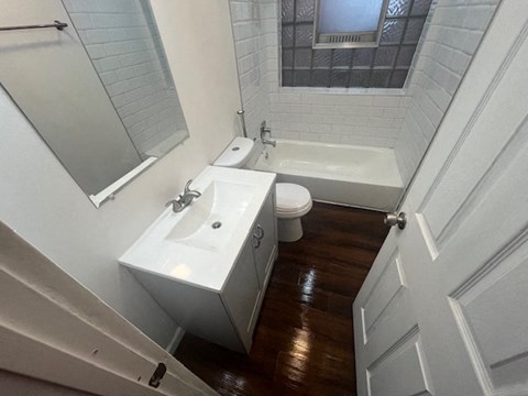 a bathroom with a sink and a toilet and a bath tub