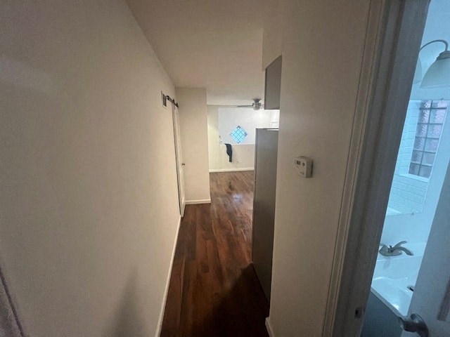 a hallway with a door to a room and a bathroom