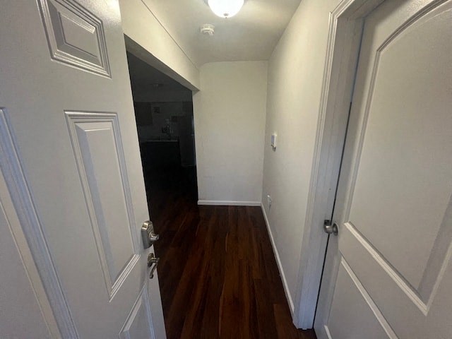 a hallway with white doors and a wood floor