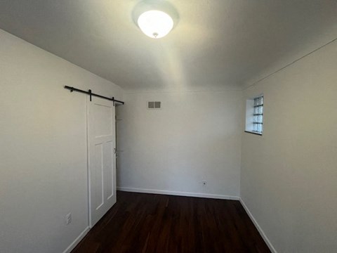 an empty room with white walls and a door