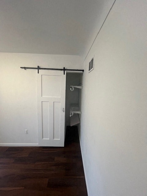 an empty room with a white door and a closet