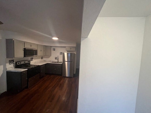 an empty kitchen with a stainless steel refrigerator
