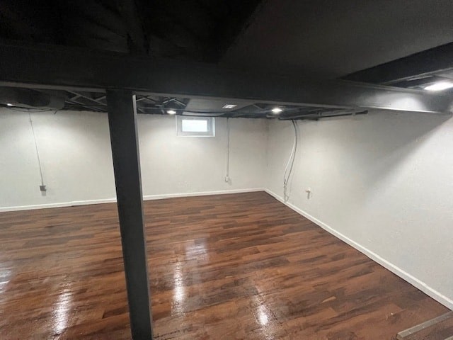 an empty room with a wooden floor and white walls