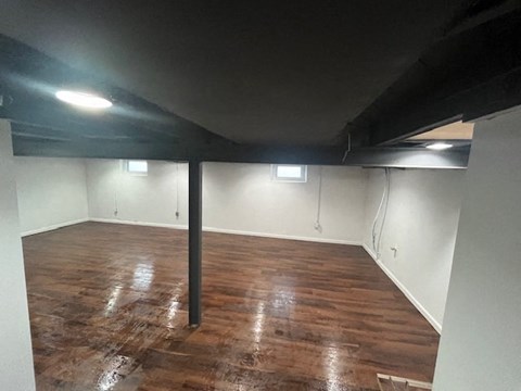 a empty room with a wooden floor and white walls