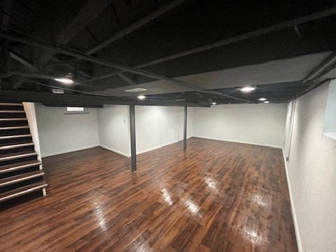 a large room with a wooden floor and white walls