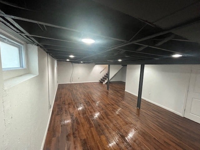 a living room with a wooden floor and white walls