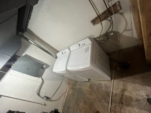 a bathroom with two washing machines on the floor