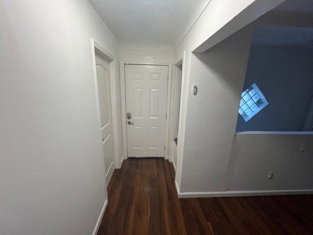 a hallway with a white door and a window