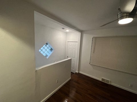 an empty room with a window and a door