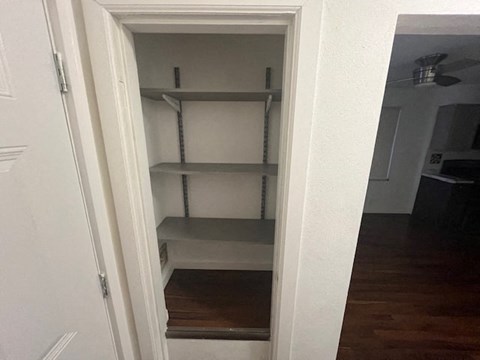 an empty shelf in a closet in a room