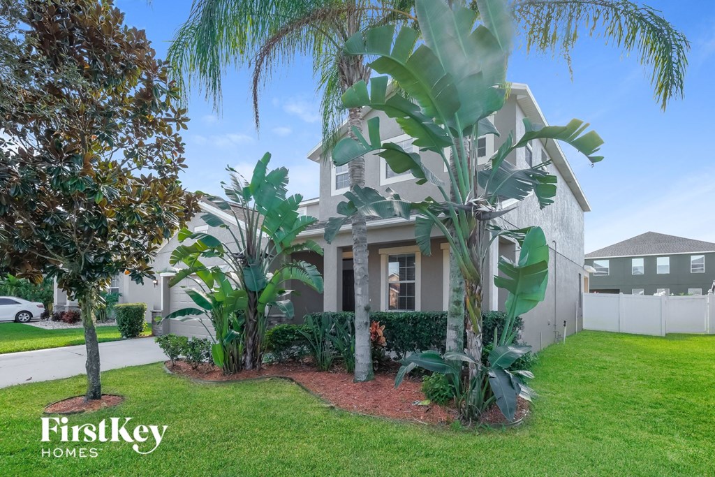a house with palm trees in front of it