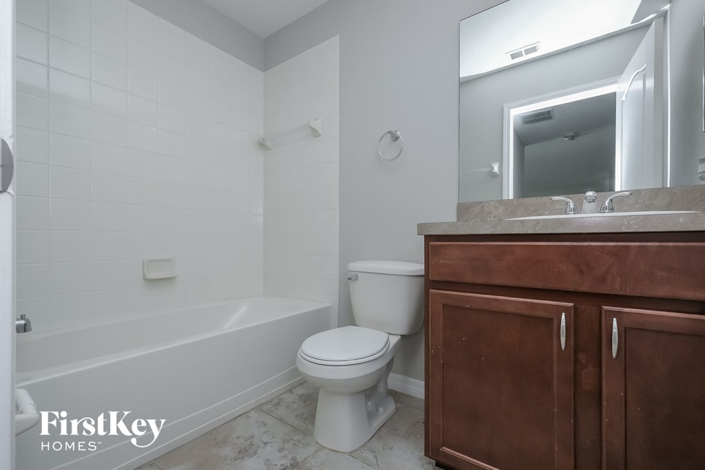a bathroom with a toilet and a sink and a bath tub