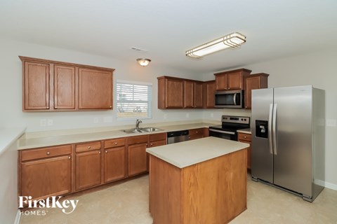 A kitchen with wooden cabinets and stainless steel appliances.