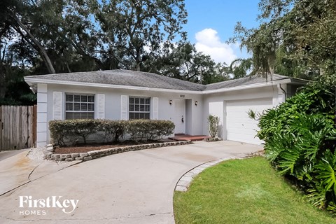 a white house with a driveway and a garage door