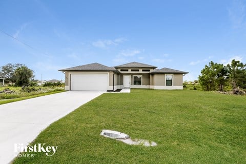 a house with a lawn and a sidewalk in front of it