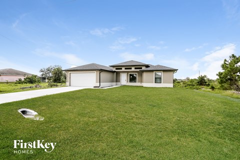 a home with a large lawn and a garage