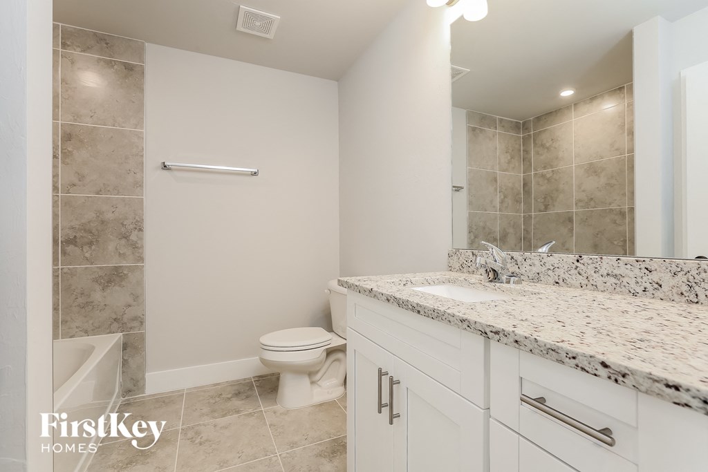 a bathroom with a toilet and a sink and a shower