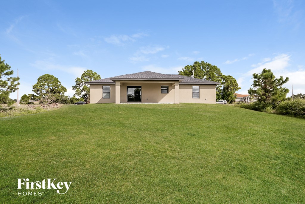a house on a hill with a grassy yard