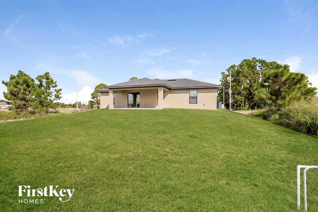 a house on a hill with a grassy yard