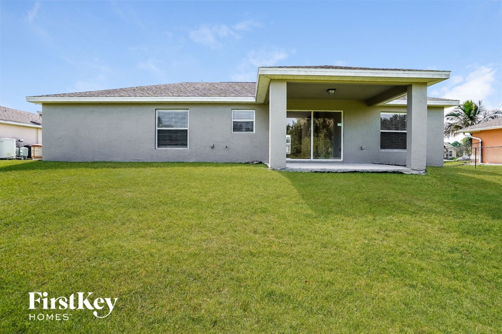 a white house with a lawn in front of it