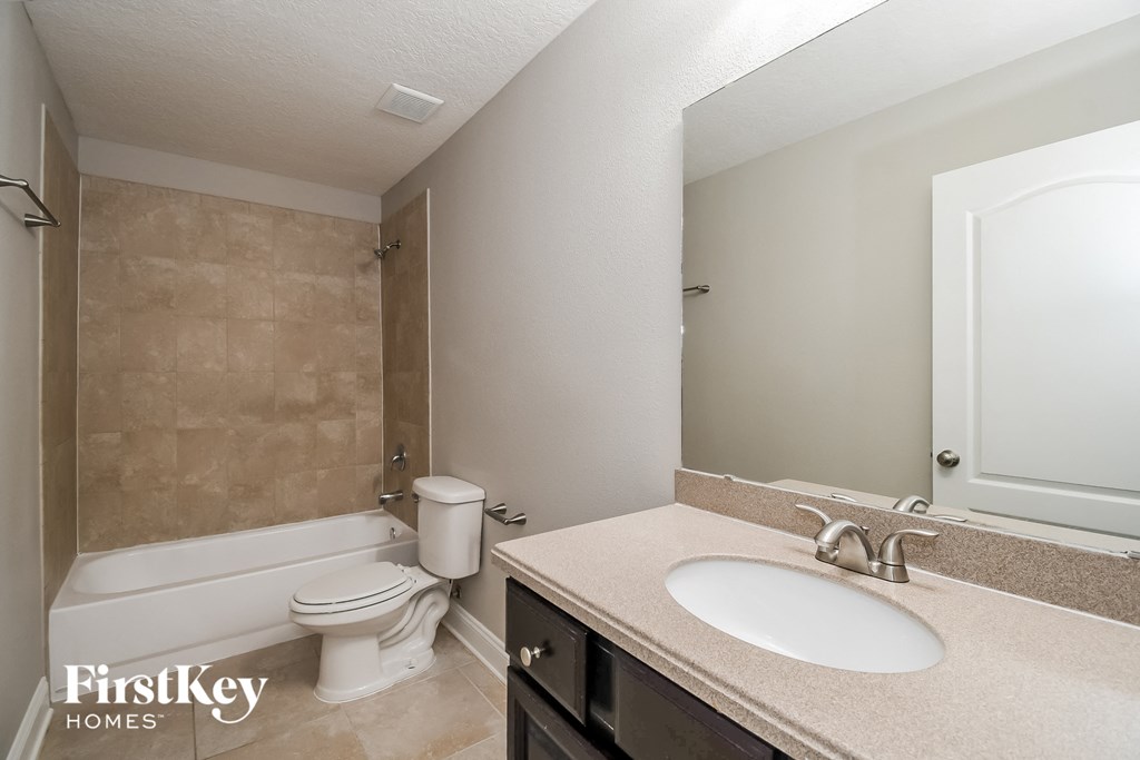 a bathroom with a sink and a toilet and a bath tub