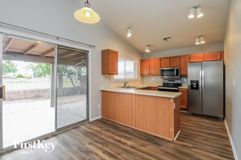 A kitchen with wooden cabinets and a refrigerator.