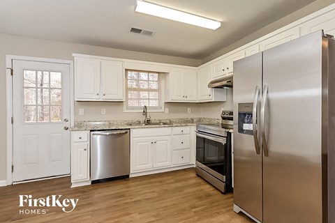 a kitchen with stainless steel appliances and white cabinets