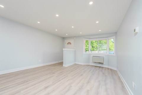 a living room with a fireplace and a window