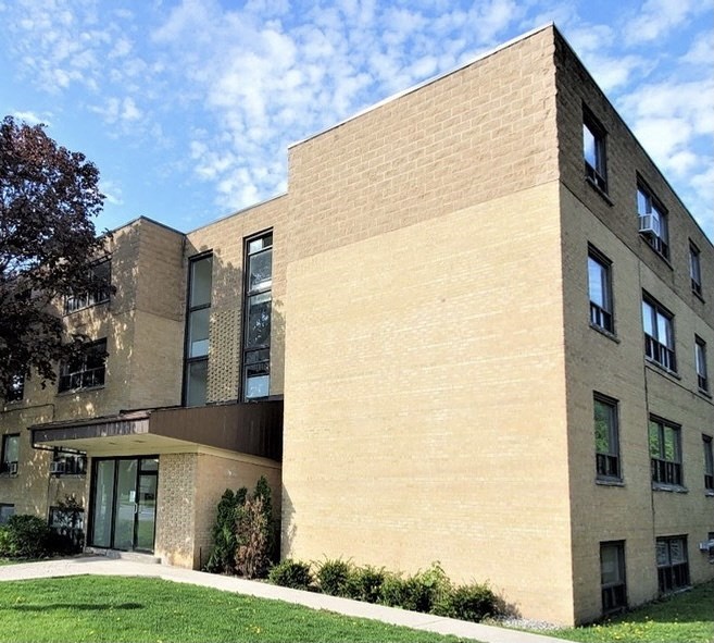a large brick building with a blue sky in the background