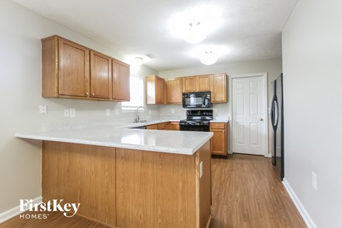 A kitchen with wooden cabinets and a white countertop.
