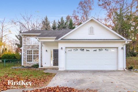 a white house with a driveway and a white garage door