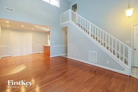 the living room and dining room with the staircase to the second floor