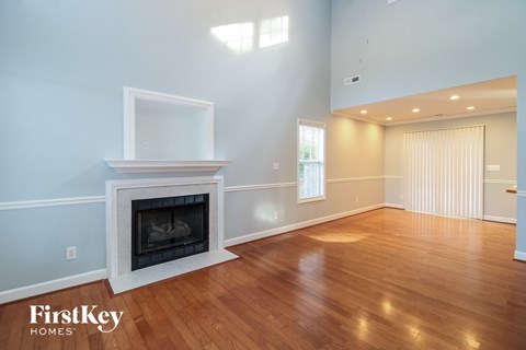 a living room with a fireplace and a wooden floor