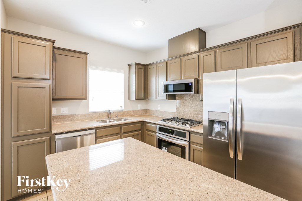 a kitchen with stainless steel appliances and granite counter tops