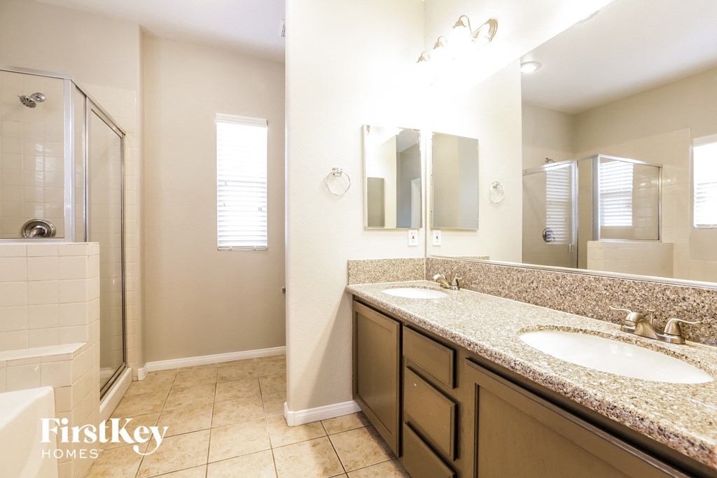 a bathroom with two sinks and a shower