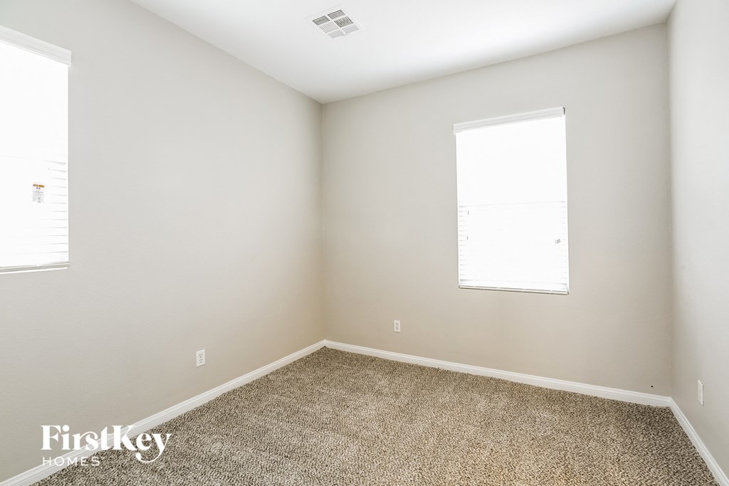 a empty room with carpet and a window
