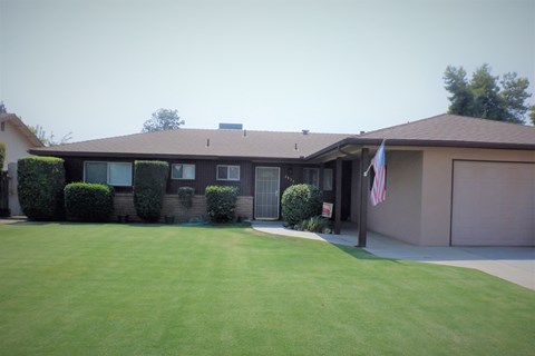 a house with an flag in the front yard