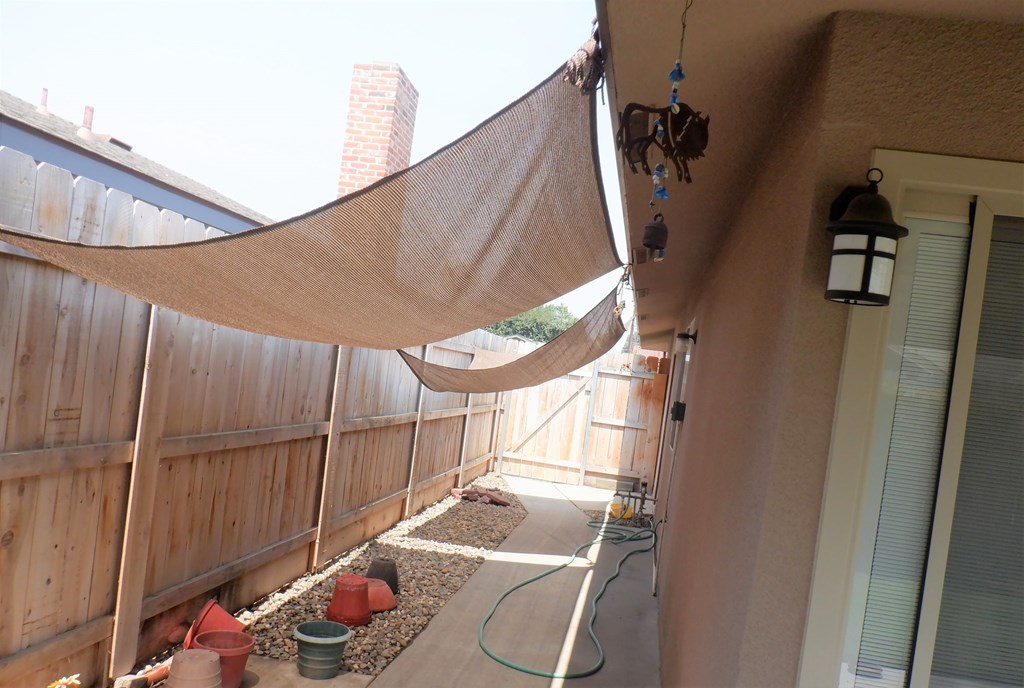 a hammock hanging on the side of a house